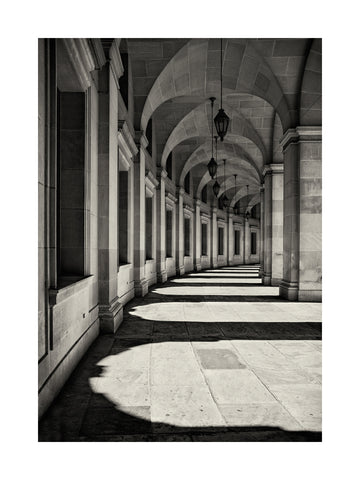 Schwarz-Weiß-Fotografie einer Arkade mit Bögen und Säulen.