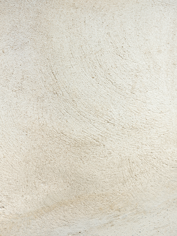 Fotografie einer beigefarbenen Struktur mit sichtbaren Strichen.