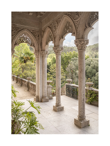 Fotografie eines Balkons mit Bögen und Blick auf einen grünen Garten.