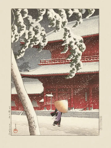 Verschneiter Yushima Tenjin Schrein in Japan mit rotem Tempel und Person im Schnee.
